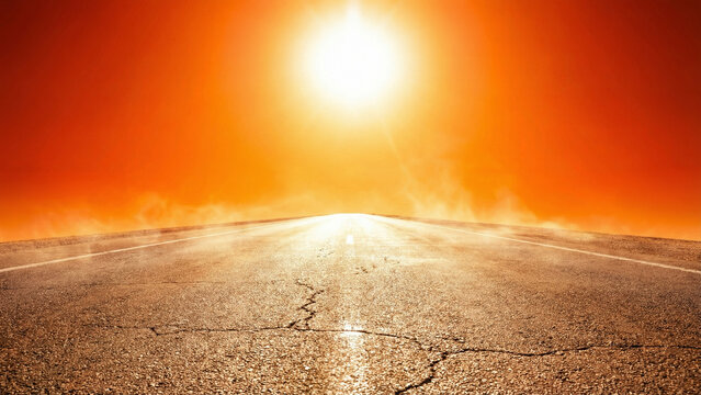 Scorching sun blazing over cracked asphalt road with heat haze and orange sky, extreme heat wave concept