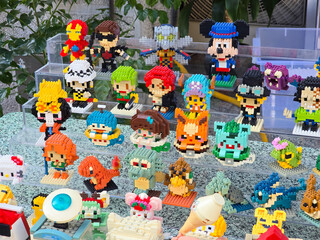 Obraz premium Taiwan, Taipei City, January 3, 2026 – Close-up of LEGO Mickey Mouse, Iron Man, Pikachu, and Anime Figures Outdoors