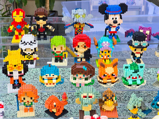 Obraz premium Taiwan, Taipei City, January 3, 2026 – Close-up of LEGO Mickey Mouse, Iron Man, Pikachu, and Anime Figures Outdoors