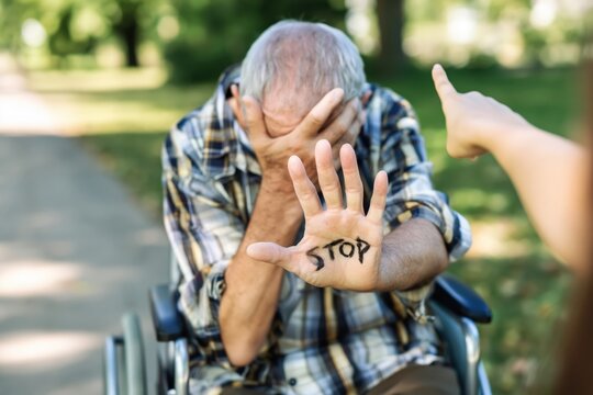 Ashamed Senior Man Shows STOP Hand While Being Berated in a Park