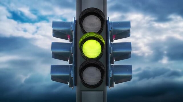 Traffic Light Transitioning Red Yellow Green Against Dramatic Cloudy Sky Background