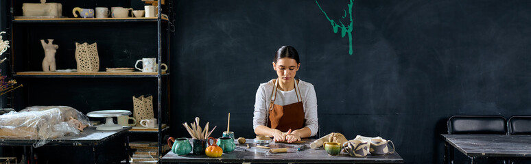 Exploring creativity in a pottery studio with a young artist at work © LIGHTFIELD STUDIOS