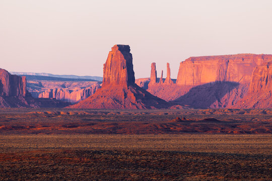 View of the iconic sandstone buttes and red rock formations of Monument Valley during golden hour in Oljato-Monument Valley, Arizona, United States.