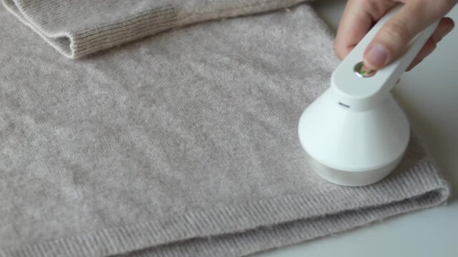 Wool sweater placed on surface prepared for fabric care routine. Textile maintenance reflects sustainable clothing habits and eco conscious wardrobe management