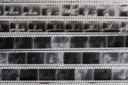 Black and white analog film contact sheet, top view. Authentic vintage photography aesthetic with film strips and frames. Vintage 35mm film