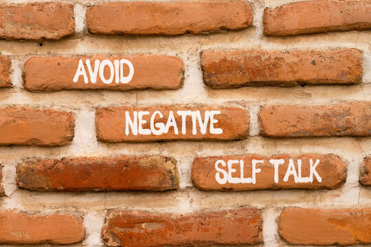 Avoid negative self-talk symbol. Concept words Avoid negative self-talk on beautiful brown brick wall. Beautiful brick wall background. Business psychology avoid negative self-talk concept. Copy space