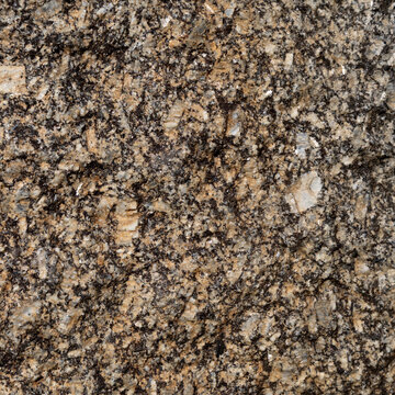 Granite rock texture with brown and black mineral patterns for background use