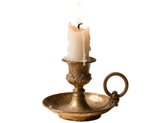 Burning candle in an ornate antique brass candlestick with dripping melting wax, isolated on...