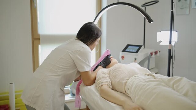 Wide shot of microblading eyebrow procedure in beauty clinic