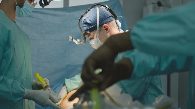 Professional team three specialist doctors performing operation help patient saving life using modern medical instruments in emergency clinic medicine process surgeons with syringe anesthesia health