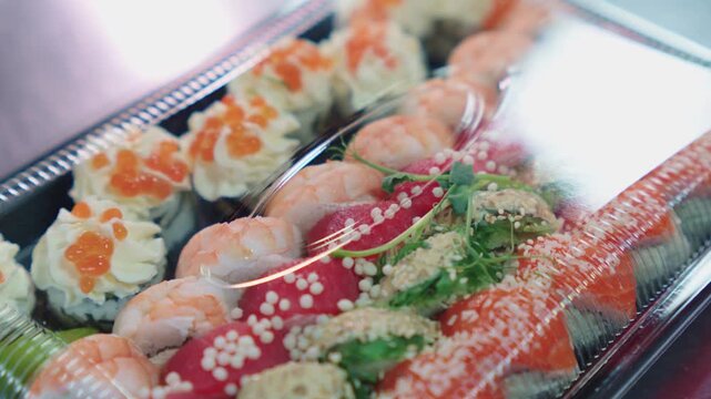 Sushi set. Japanese food. Different types of sushi beautifully arranged in plastic packaging. Different sushi in the set. Colorful colors and flavors.