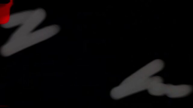 Chaotic animated scribbles numbers and symbols on black screen