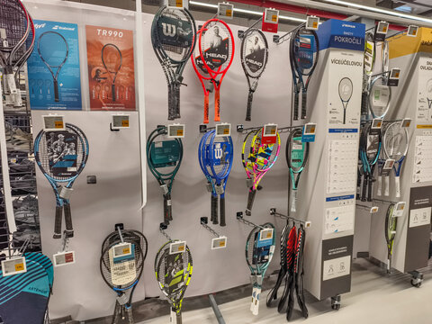 Prague, Czech Republic - March 31, 2026: Interior of a sporting goods store with a large display of tennis rackets and sports equipment in Prague.