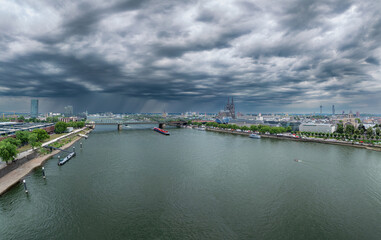Obraz premium Dramatic View of Urban Cologne City Skyline and River Under Stormy Sky. Germany
