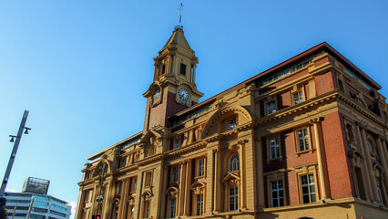 Fototapeta premium Auckland, New Zealand - Mar 4. 2026: The facade of the Auckland Ferry Building listed as a Category I historic place housing various restaurants, shops, and offices. For Editorial Use Only.