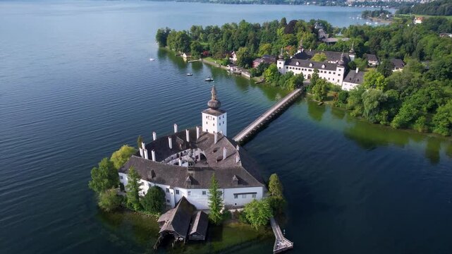 Austria Gmunden 4K Aerial Drone Video of Schloss Ort Castle on Traunsee Lake at Morning Sunrise Scenic Orbit Flight with Long Wooden Bridge and Alpine Mountain Landscape