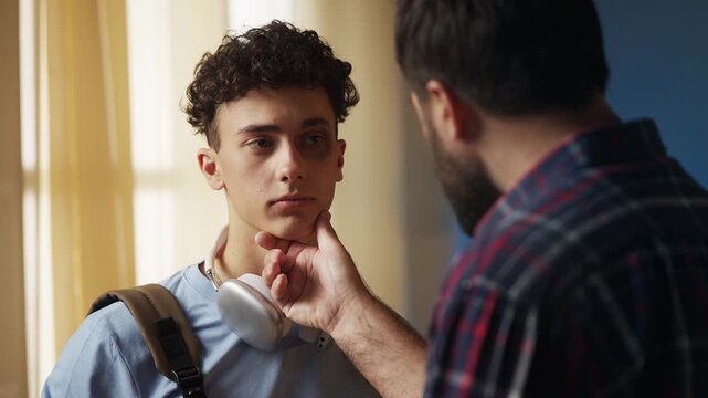 Dad talking to son who came with bruised eye from school, teaching moral values