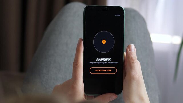 Close-up of a woman using RapidFix app to call a repair master. She taps Locate Master button. Modern on-demand service for home appliances. High-quality footage for tech, lifestyle, and household
