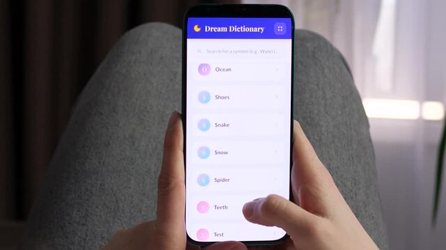 POV shot of a person searching for dream interpretations. Interface shows a digital encyclopedia of subconscious symbols. Ideal for esoteric content, psychological research videos, and modern