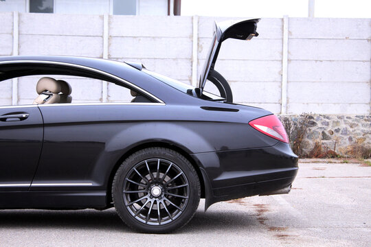 Vinnytsia, Ukraine; November 8, 2025. Black Mercedes-Benz CL AMG open trunk at the parking. German lux car Mercedes-Benz CL AMG trunk in city street. Open empty trunk in premium sedan. Car boot space.