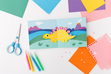 handmade paper craft dinosaur stegosaurus landscape background creative art lesson elementary school education childhood hobby DIY project preschool activity creative development imagination skills © Elena