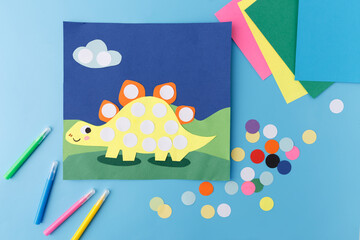 Dinosaur paper craft yellow stegosaurus colorful paper circles child art school project creative hobby education preschool learning activity kindergarten background children development toys © Elena