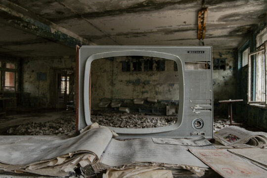 View of an old television set and scattered papers inside a decaying room within the Chernobyl Exclusion Zone Pryp'yat', Kyiv Oblast, Ukraine.