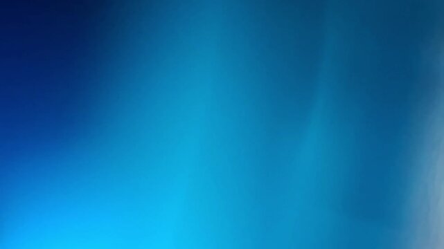 A long, mesmerizing cinematic loop of soft blue light leaks and ethereal cyan gradients flowing smoothly, creating a tranquil and modern abstract background for high-end tech or meditation visuals.