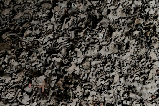 View of a massive pile of discarded old gas masks covering the floor of an abandoned school in the Chernobyl Exclusion Zone Prypyat, Kyiv Oblast, Ukraine.