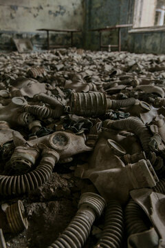 View of hundreds of discarded gas masks covering the floor of an abandoned school building in Pripyat, Kyiv Oblast, Ukraine.