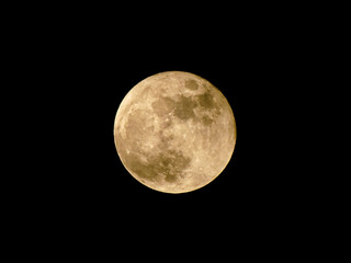 Naklejka premium Full moon with visible craters and shadows, moonlight, circle moon phase on black background. Small cloud in front of super moon.