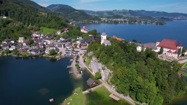 Austria Traunkirchen 4K Aerial Drone Video Cinematic Orbit Around Scenic Peninsula with Ancient Monastery and Church on Traunsee Lake Alpine Mountain Landscape