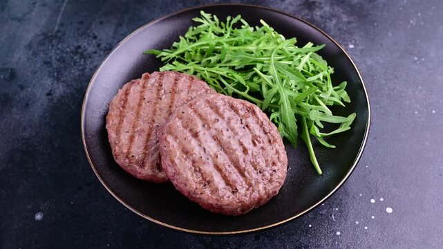 Cooking plant-based burgers with fresh arugula in a modern kitchen