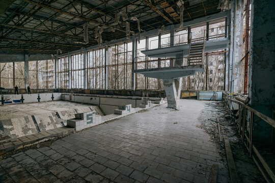 View of the abandoned Azure Swimming Pool with its diving board and empty tiled basin in Pryp'yat', Kyiv Oblast, Ukraine.