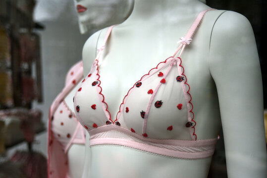 closeup of pink bra with little hearts on mannequin in a fashion store showroom 
