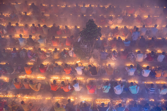 Baradi, Bangladesh - 09 November 2024: View of devotees sitting with oil lamps during the Rakher Upabash festival at Sri Sri Loknath Bramhachari Shomadhi Mondir.