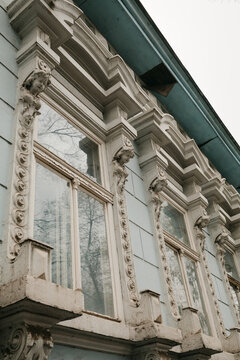 Decorative facade details with sculptural ornaments on historic building in Senta Serbia, highlighting classical design and architectural craftsmanship.