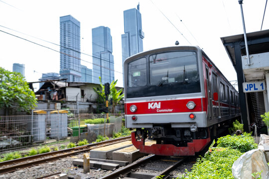 Jakarta, Indonesia - March 24, 2026: A KAI Commuter train stands at Karet Station with the skyscrapers of Jakarta&rsquo;s Sudirman business district in the background.
