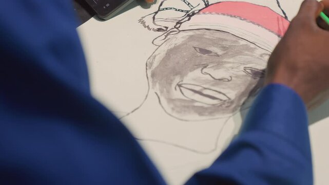 Black painting portrait receiving final green pencil touches on canvas, artist refining outline, upbeat subject sketch with pink headwrap, blue sleeve, professional studio light, poised strokes