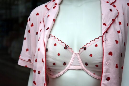 closeup of pink bra with little hearts on mannequin in a fashion store showroom 