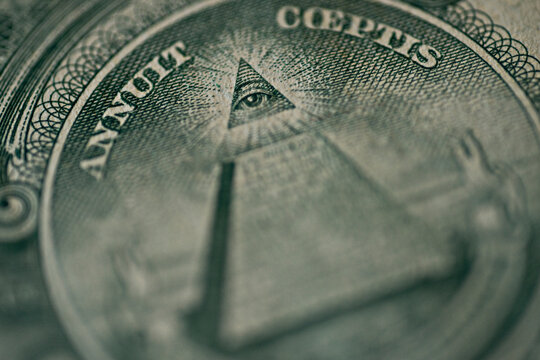 Extreme macro close-up of the All-Seeing Eye on the pyramid from the US one dollar bill. Detailed engraving of the Great Seal for conspiracy, finance, and American history themes.