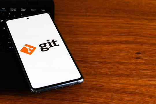 Punta Arenas, Chile &ndash; March 31, 2026: The Git logo and text displayed on a smartphone screen resting on a wooden desk