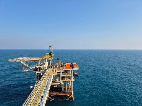 An offshore wellhead platform with a connecting bridge to it.