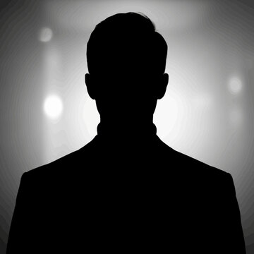 Silhouette of a Man in a Suit Against a Light Background.