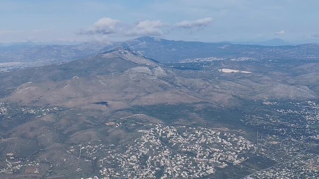 Aerial footage of Zoumperi beach and Nea Makri coastline in Greece, near Athens. Scenic flight over the Aegean Sea shore, showing turquoise waters, coastal settlements, and the Attica mountains