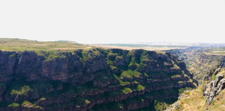 Rugged Rock Cliff Face with Green Vegetation, view from the top of the mountain lori canyon, Armenia