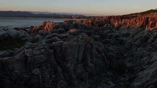 Rocky coastline, DeKelders,  South  Africa, overlooking Walker Bay Nature Reserve and Klein Mountains