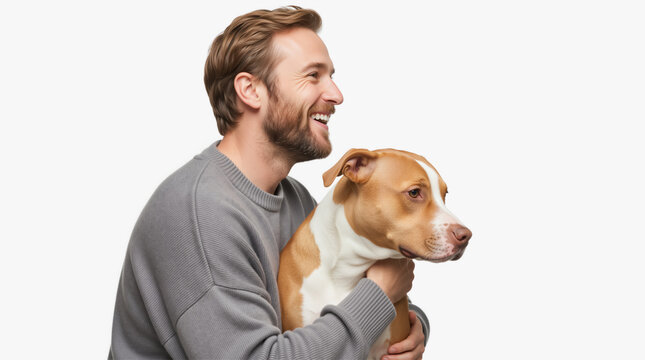 Bearded man hugging a tan and white pit bull mix dog. Happy pet owner with rescue animal on white background. National Rescue Dog Day and National Mutt Day