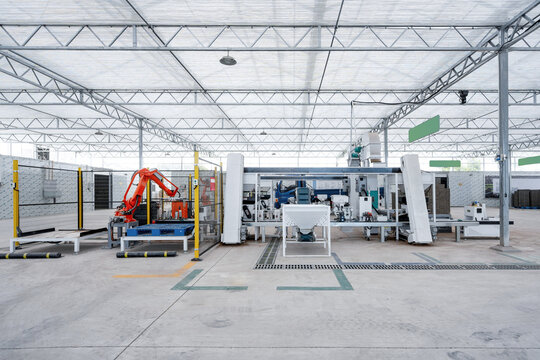 Factory automated production line with robotic arm performing material handling tasks