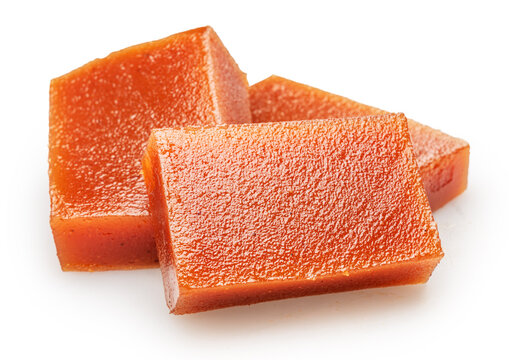 Quince paste cubes or quince marmalade cubes on white background. File contains clipping paths.